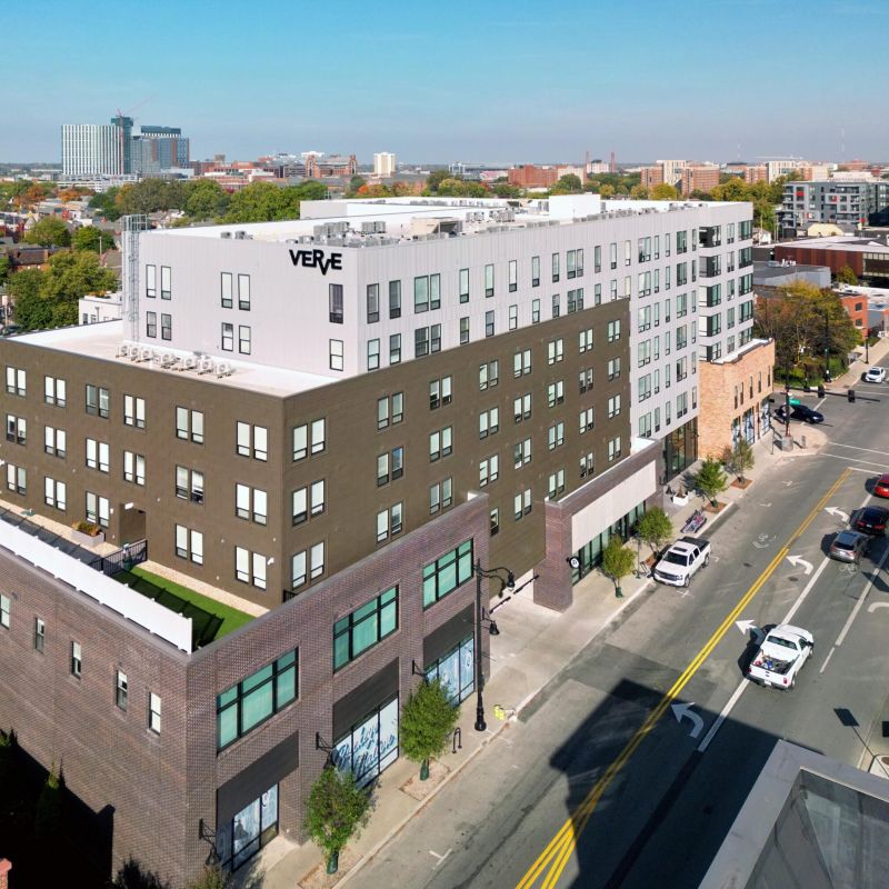 Aerial view of VERVE Columbus, a modern multi-story apartment building located in the heart of the city, surrounded by shops, streets, and skyline views.