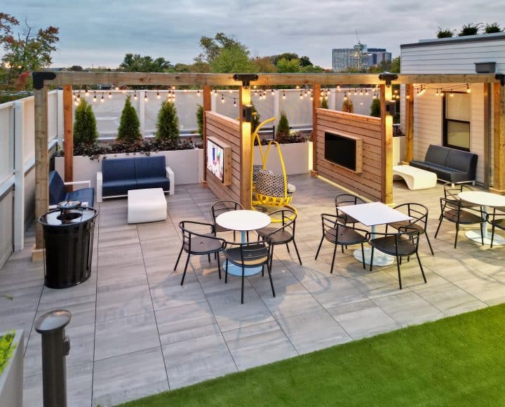 The Verve Columbus student apartments outdoor lounge with couches, eating tables, and TVs