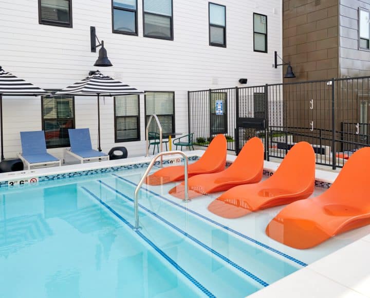 The Verve Columbus student apartments pool area with wading chairs