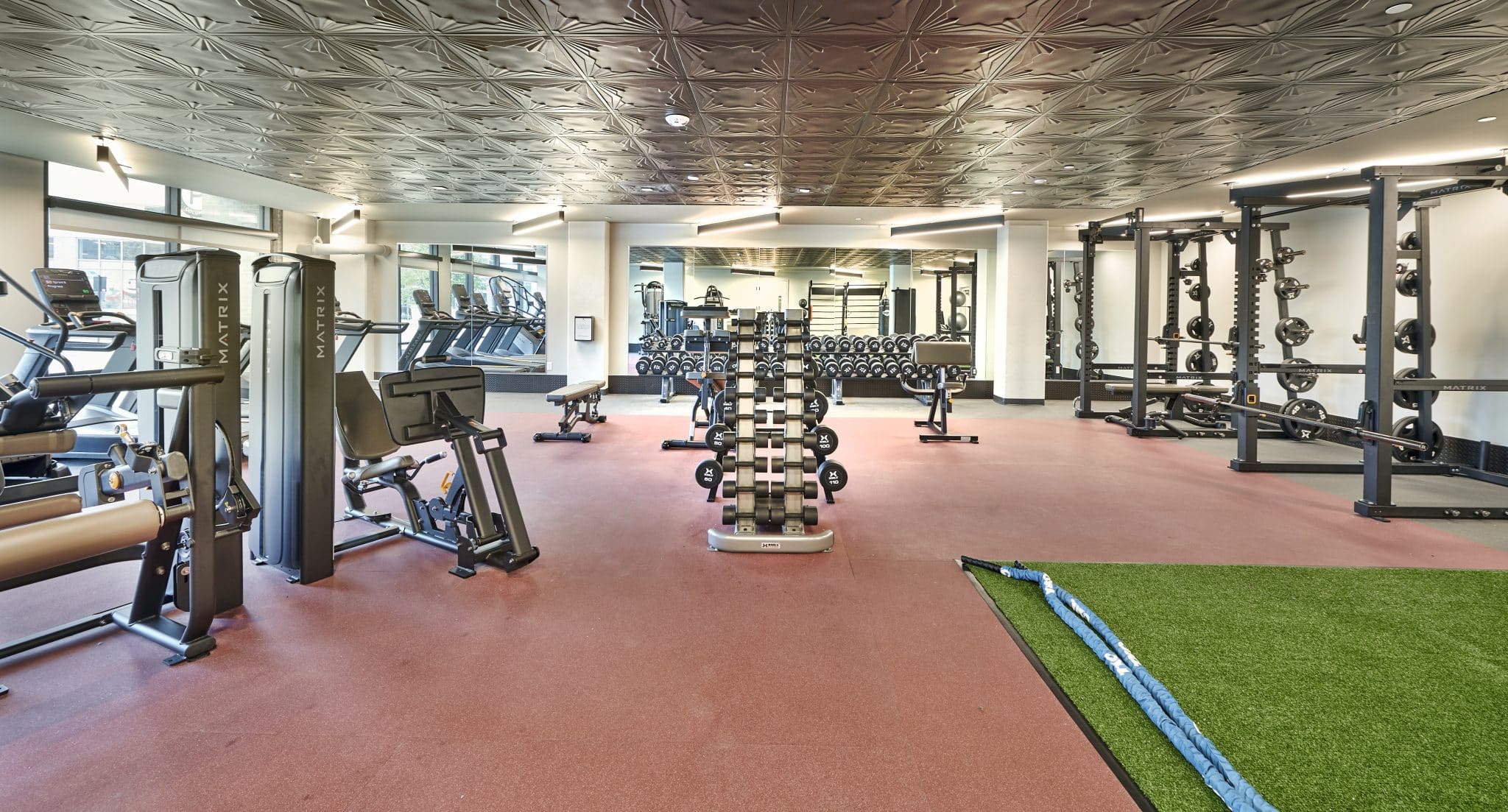 The Verve Columbus luxury student apartments fitness center with weight machines and turf area