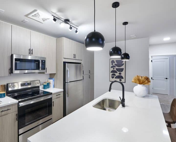 The Verve Columbus luxury student apartments kitchen area with stainless steel appliances and bar area