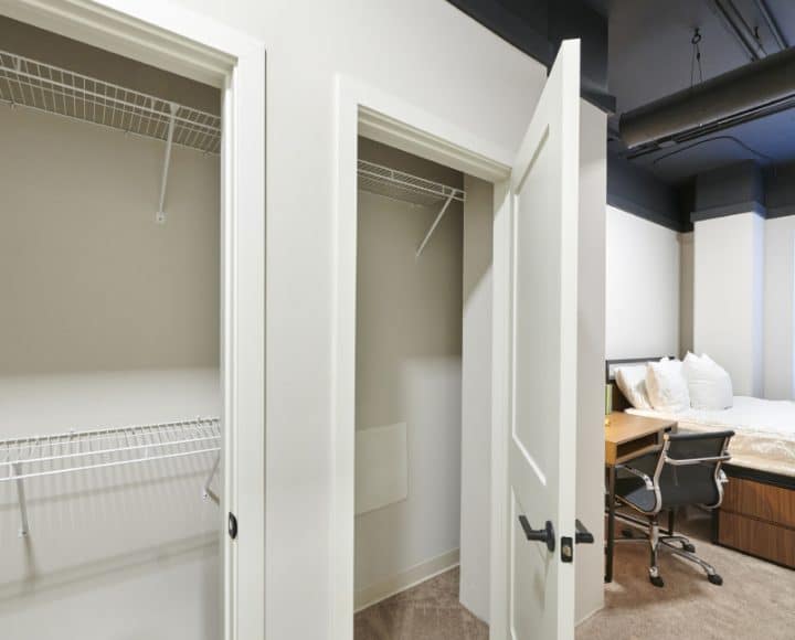 The Verve Columbus luxury student apartments in-unit bedroom with bed, desk and chair, and closets